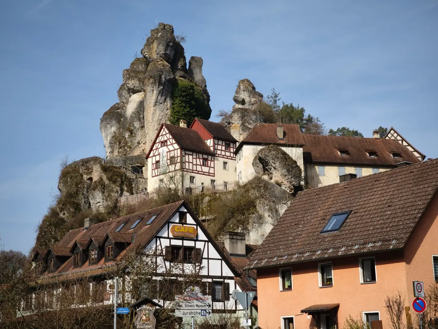 Picturesque village houses with traditional architecture beneath stunning rock formations.