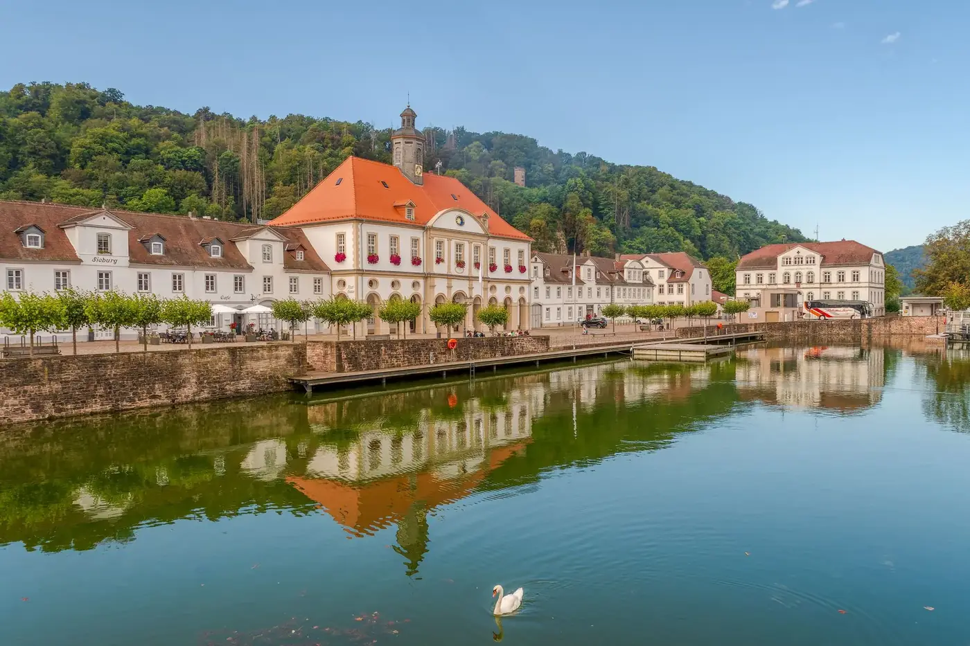 Scenic view of historic buildings reflected on the Weser river in Bad Karlshafen, Germany.