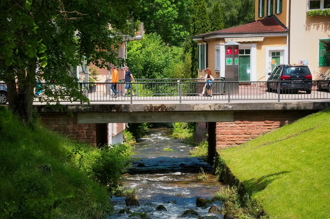 Picturesque bridge crossing a stream in Bad Liebenzell, Germany on a sunny day.