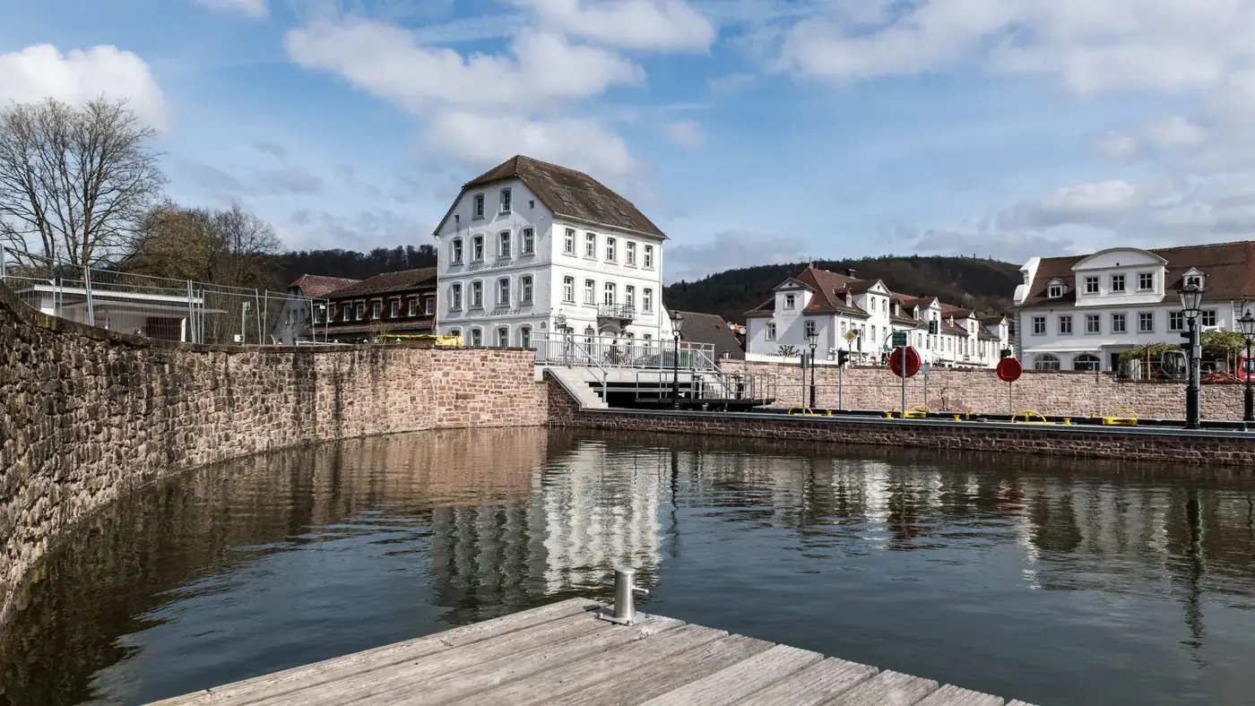 Charming view of historic architecture and calm waters in Bad Karlshafen, Germany.
