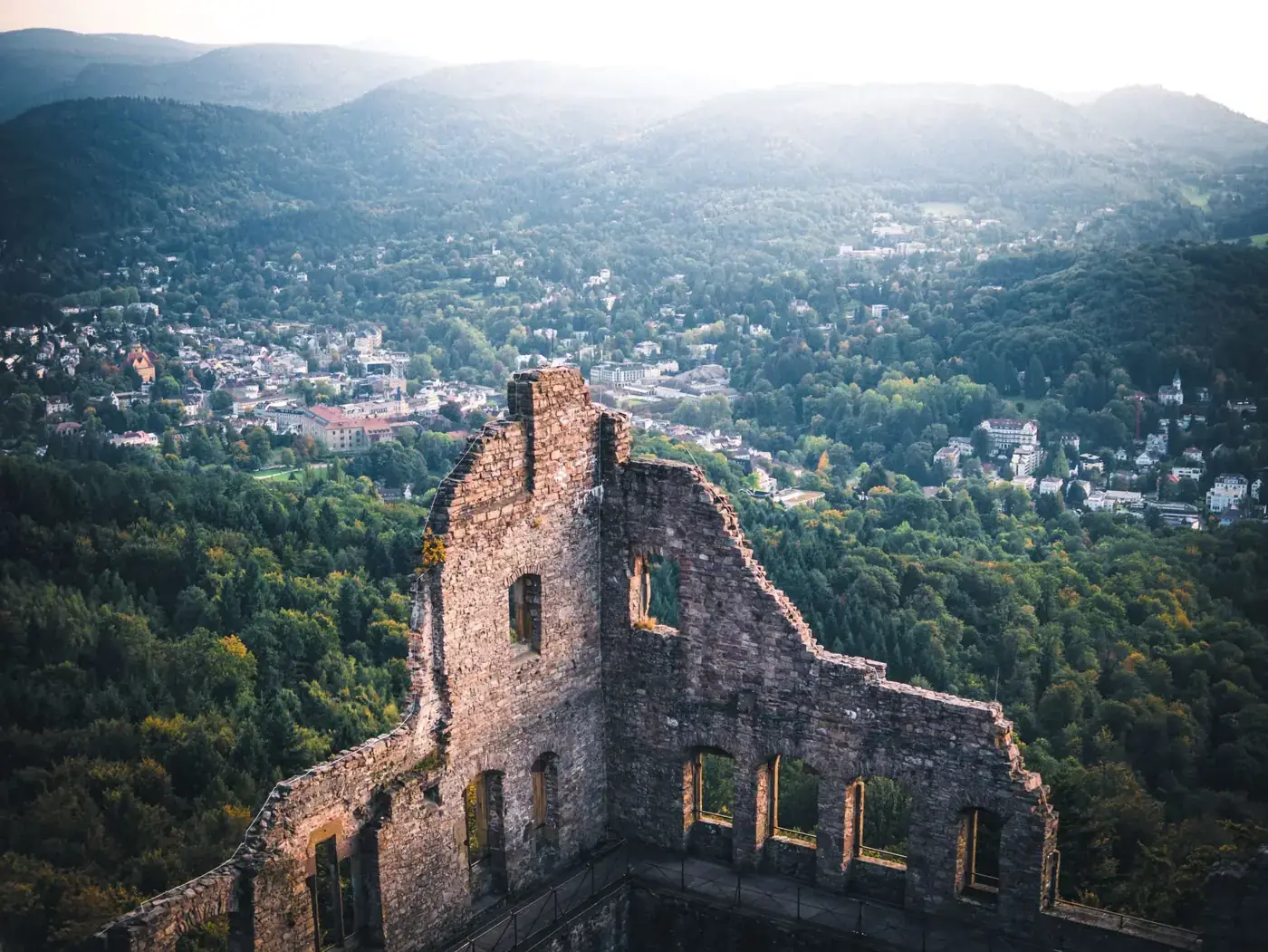 Stunning aerial view of Hohenbaden Castle ruins in Baden-Baden, Germany amidst lush forests.