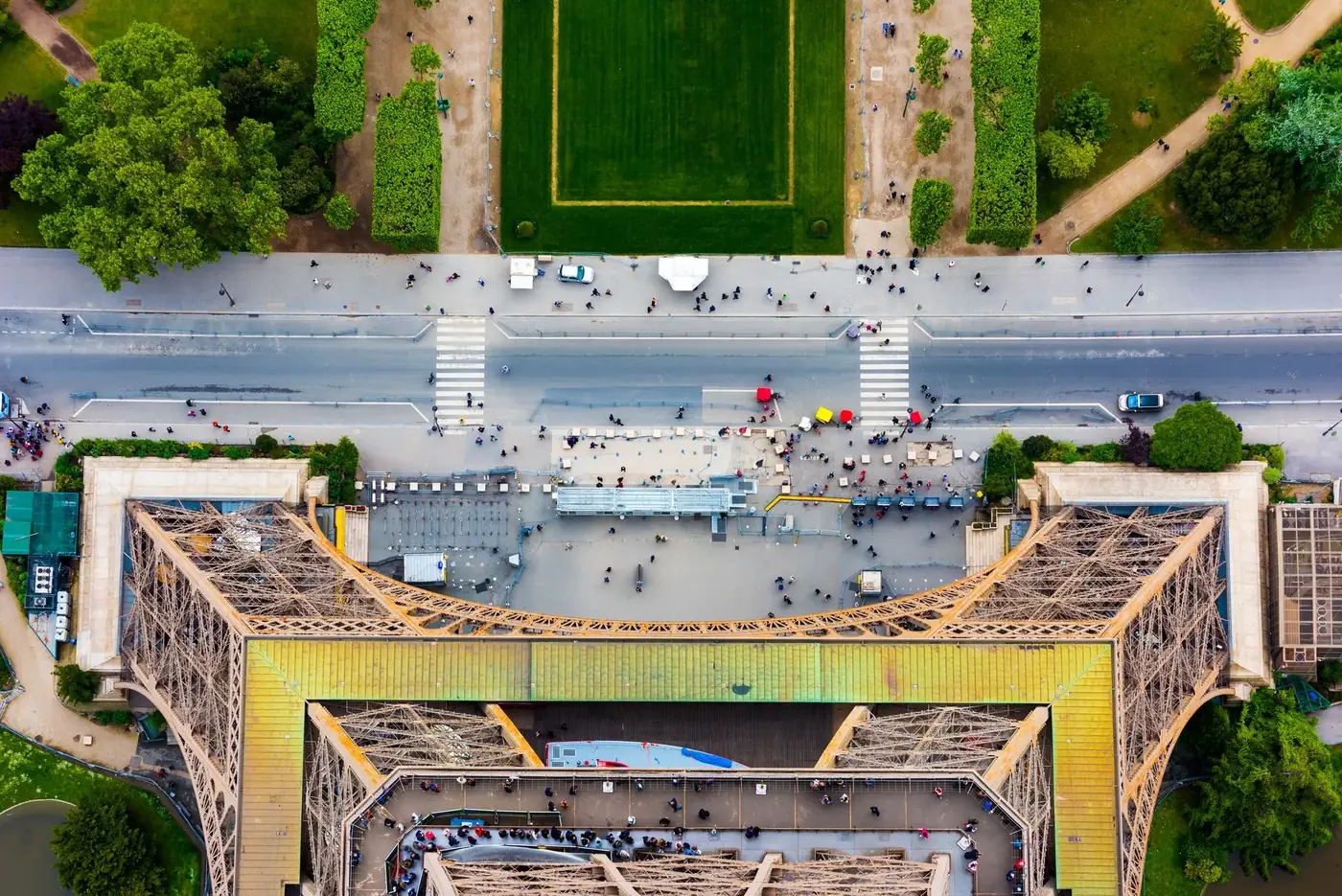 A vibrant aerial shot capturing the top view of the Eiffel Tower and surrounding Parisian landscape.