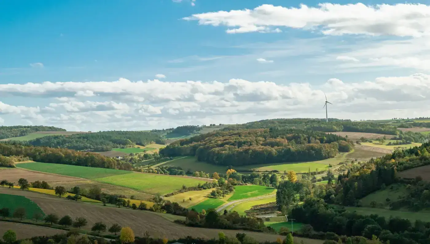 A panoramic view of rolling hills and wind turbines in autumn in Bad Mergentheim, Germany.
