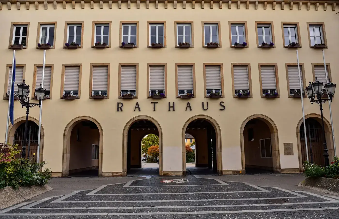 Exterior view of the Rathaus building in Frankenthal, Germany, showcasing its architectural arches and facade.