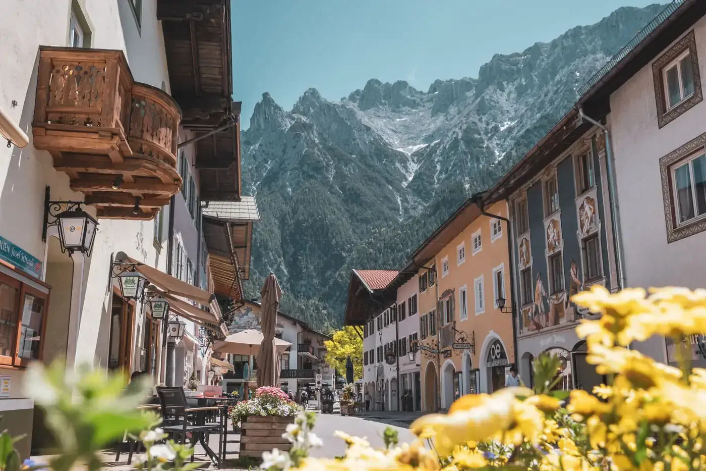 Picturesque street in Mittenwald, Germany showcasing traditional Bavarian architecture with impressive mountain backdrop
