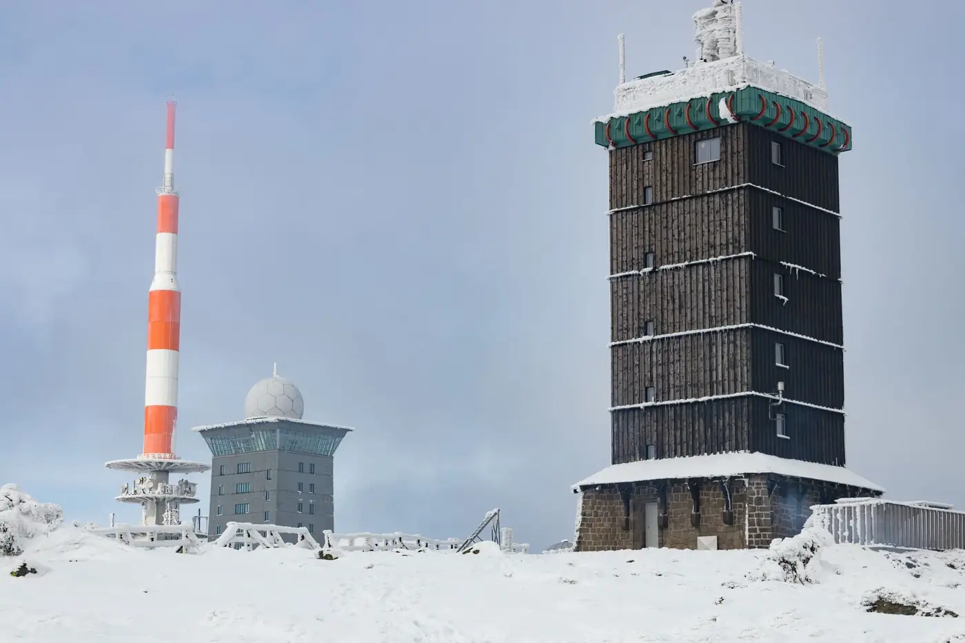 Three towers on snow-covered Brocken Mountain in Saxony-Anhalt during winter.