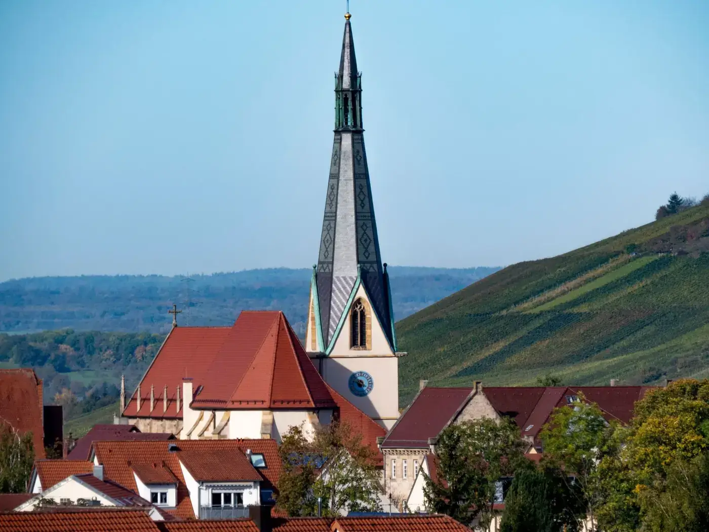Gothic church tower in Dettingen an der Erms, Germany, surrounded by rural landscape.