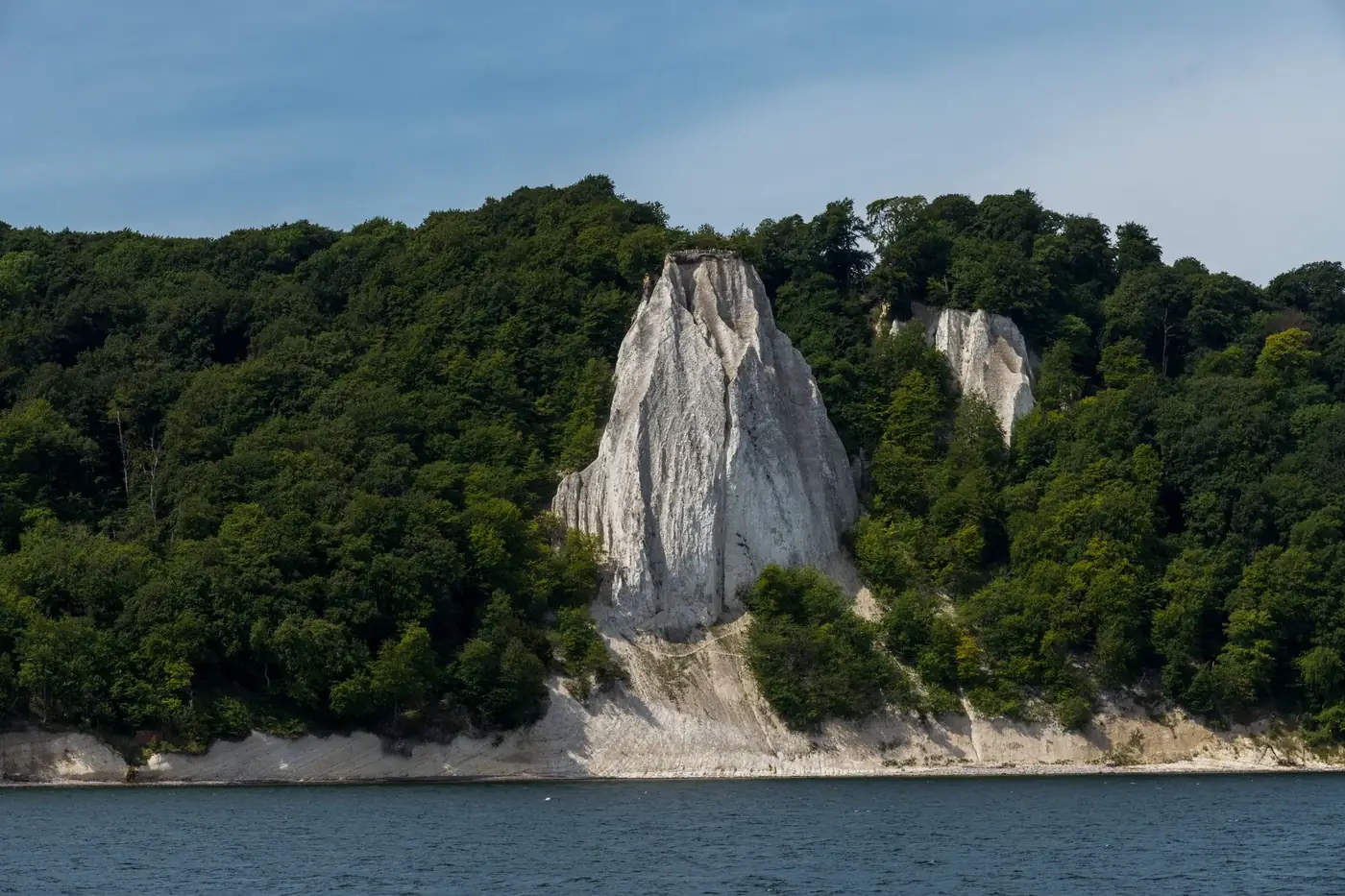 Breathtaking view of Königsstuhl chalk cliffs amidst lush greenery by the Baltic Sea.