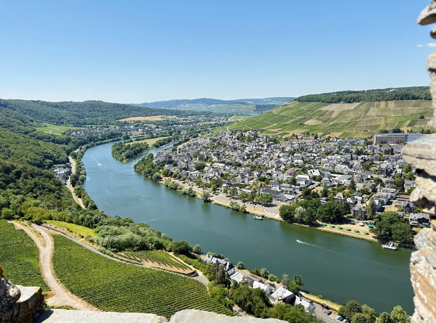 Breathtaking aerial view of Bernkastel-Kues along the Moselle River in Germany, showcasing lush vineyards and charming a
