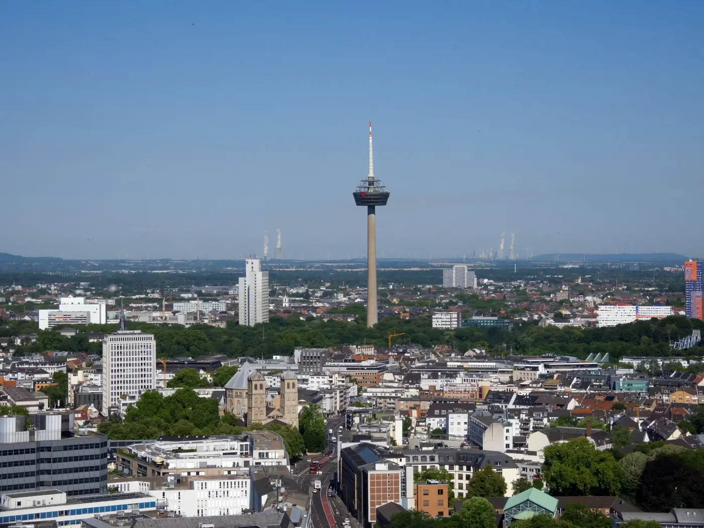 Stunning aerial view of Cologne featuring the iconic Colonius TV Tower under a clear blue sky.