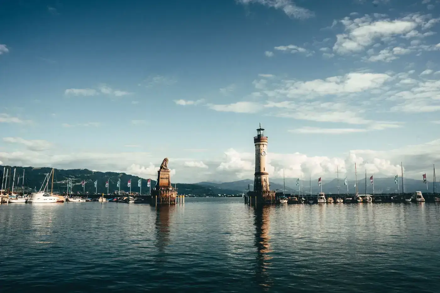 Beautiful landscape of Lindau Harbor featuring the iconic lighthouse and lion statue at Lake Constance.