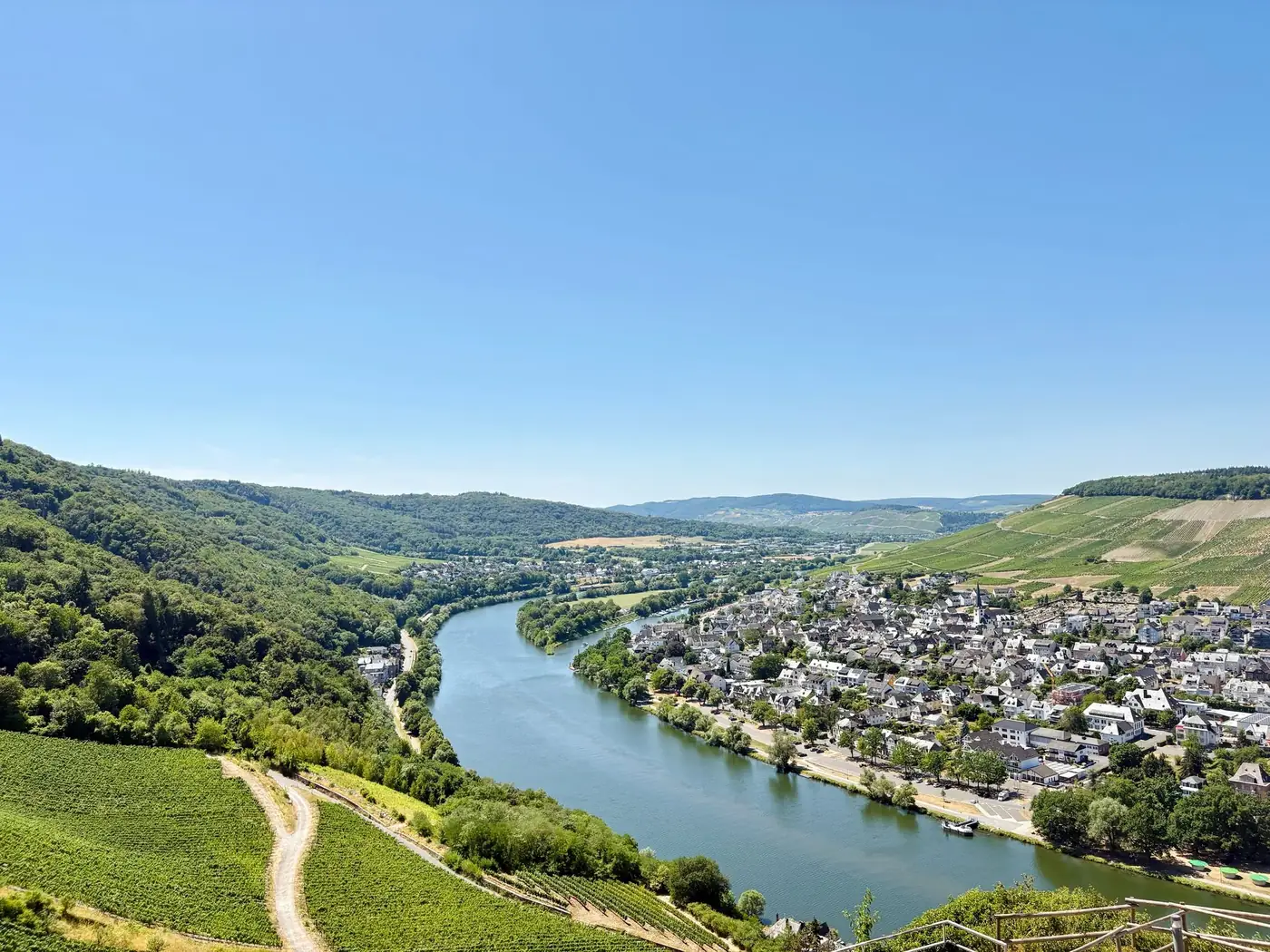 Stunning aerial view of Bernkastel-Kues, Germany with the Moselle River and vineyards in summer.