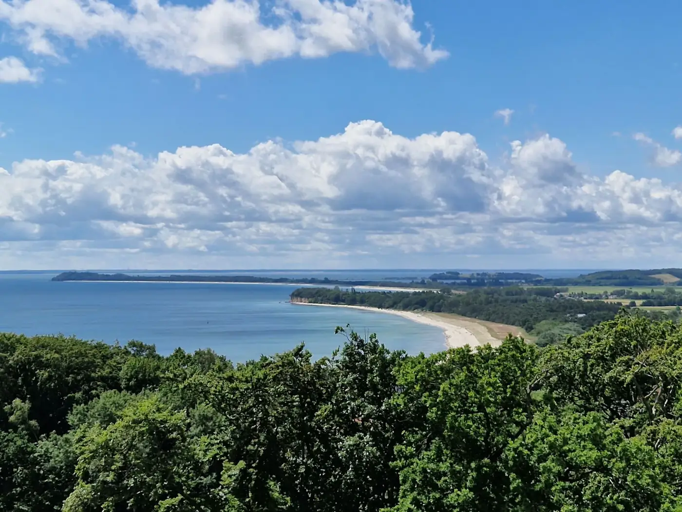 Breathtaking view of the coast in Göhren, Germany, under a vibrant blue sky.