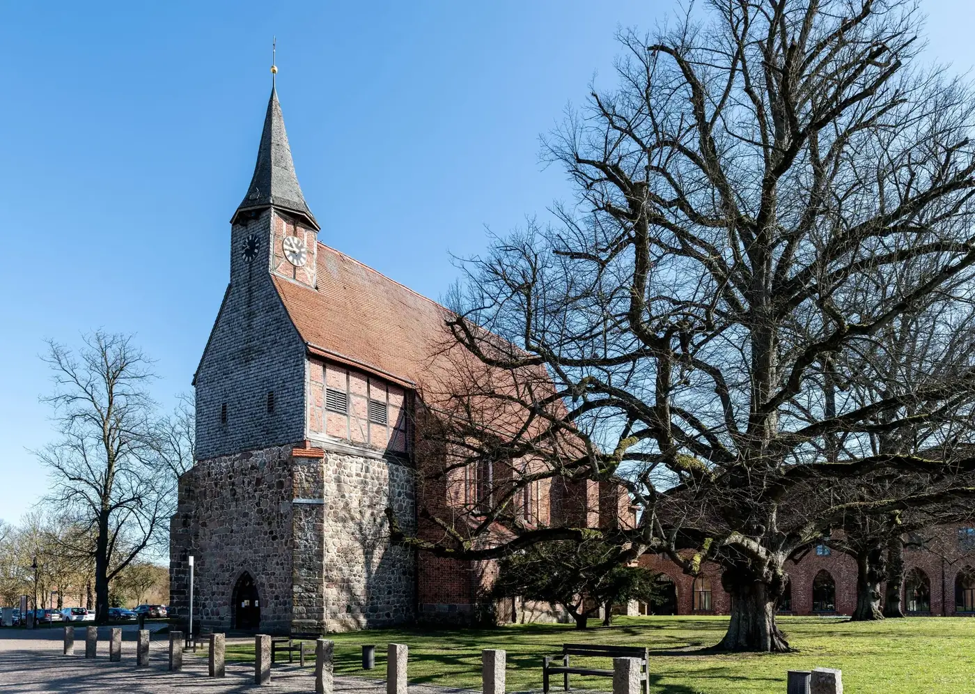 Explore the rustic charm of a historic brick church surrounded by bare trees in Zarrentin am Schaalsee, Germany.