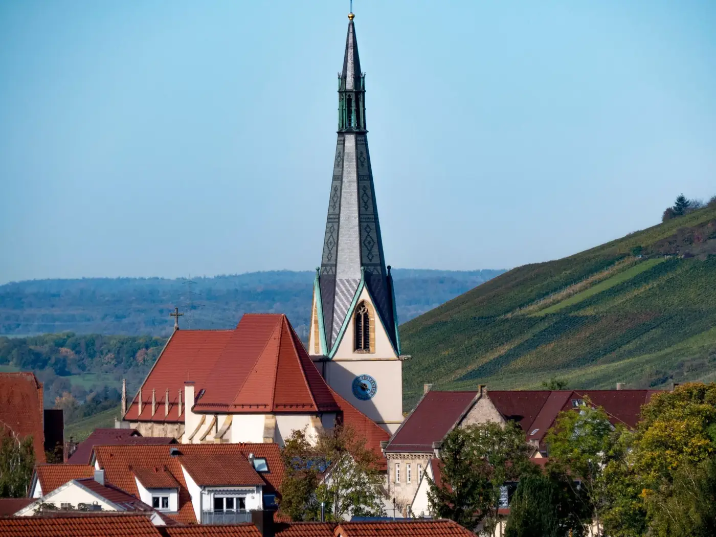 Gothic church tower in Dettingen an der Erms, Germany, surrounded by rural landscape.