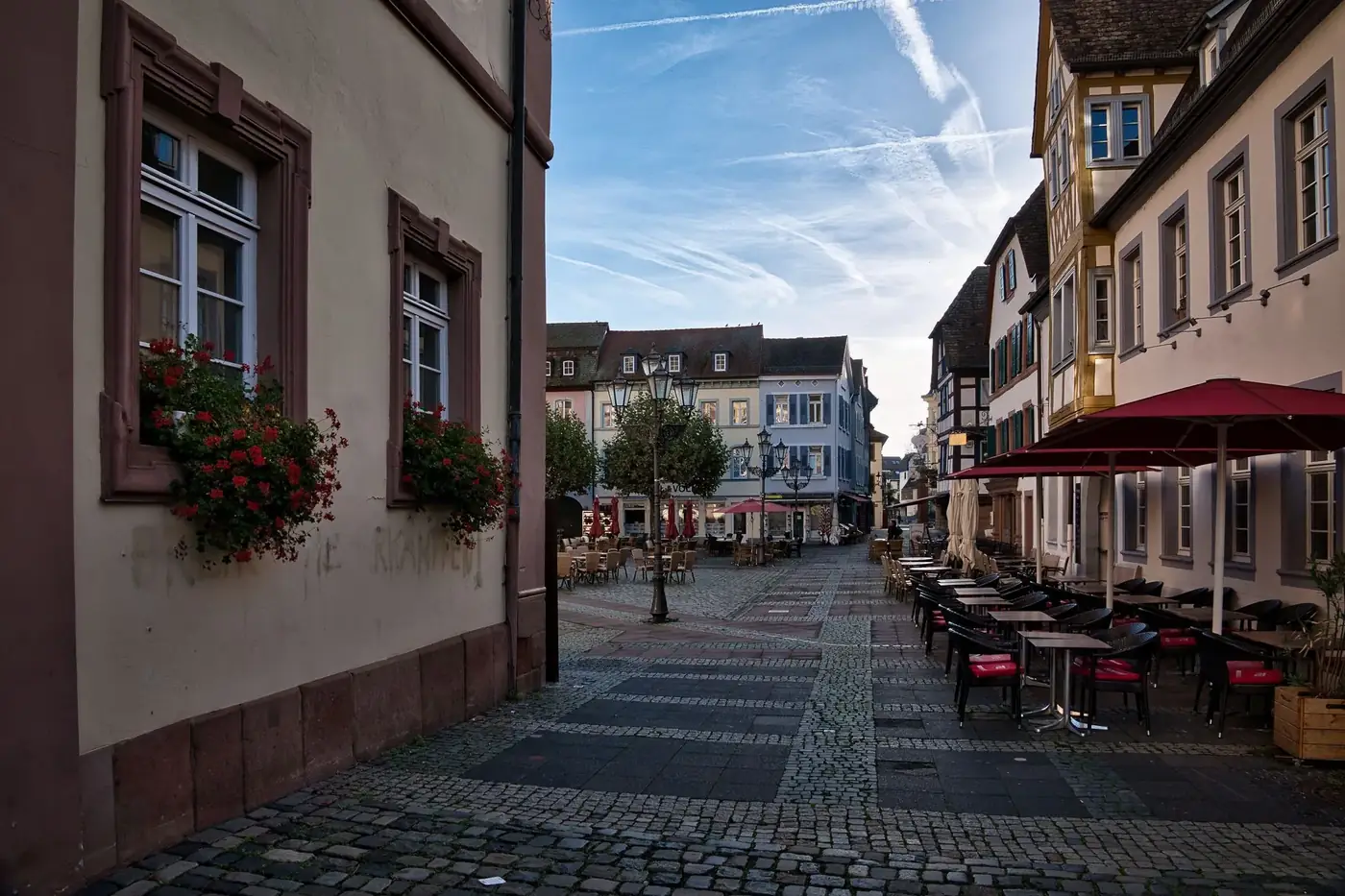 Picturesque town square in Neustadt an der Weinstraße, featuring historic architecture and a quaint cafe.