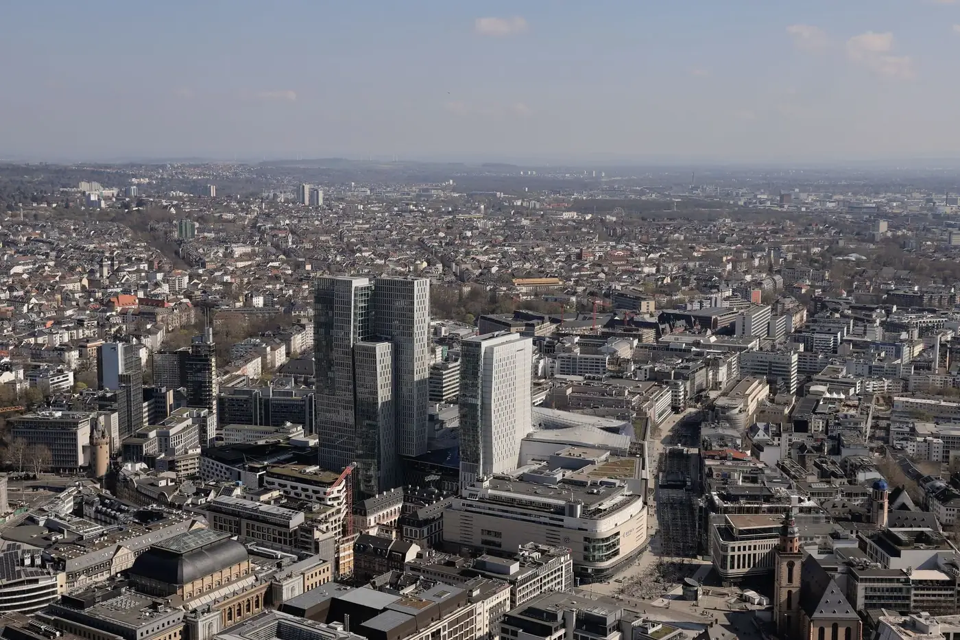 Captured from above, showcasing Frankfurt's skyline with modern skyscrapers and expansive cityscape.