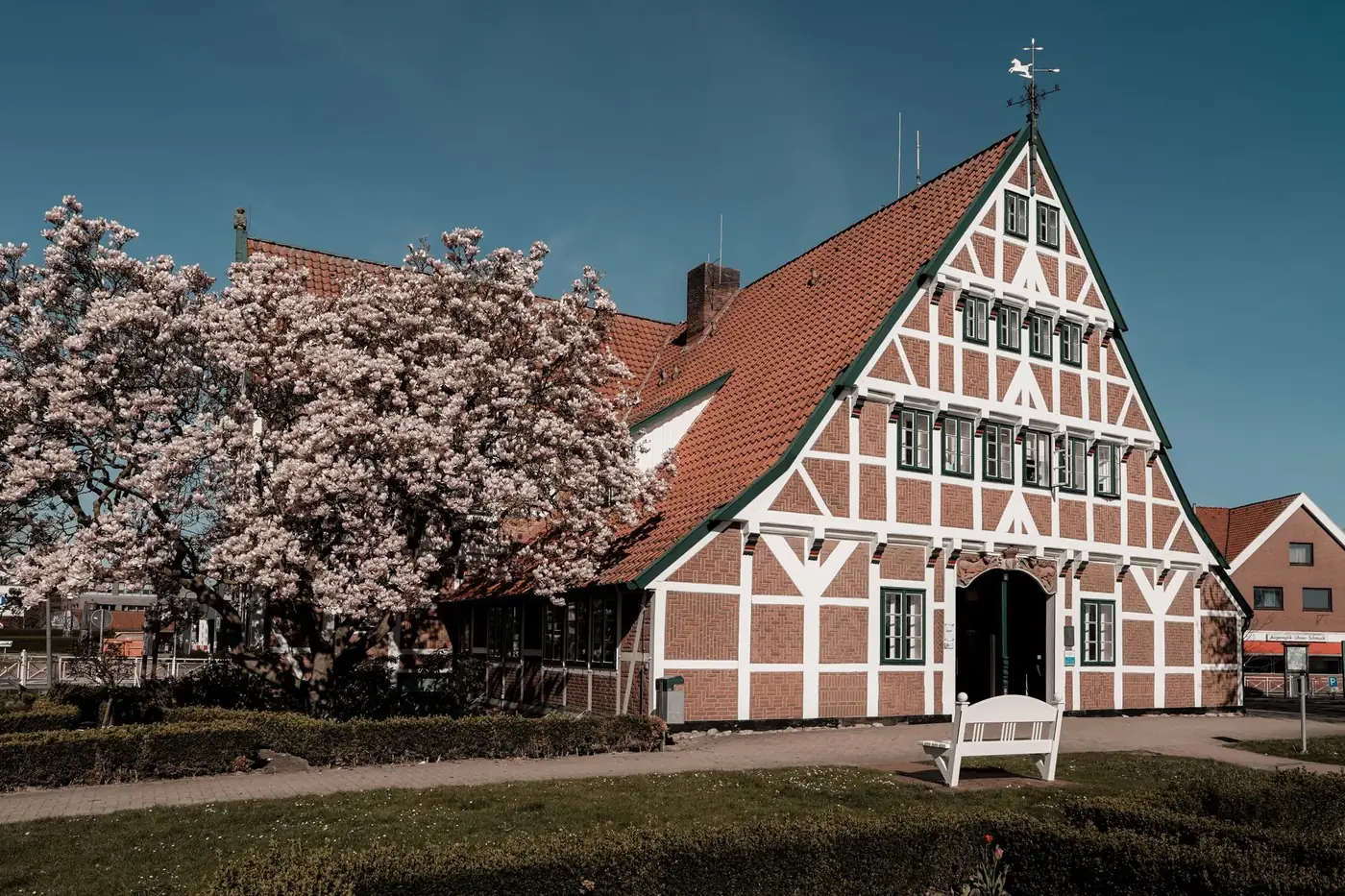 Historic timbered house surrounded by blossoms in Jork, Germany during spring.