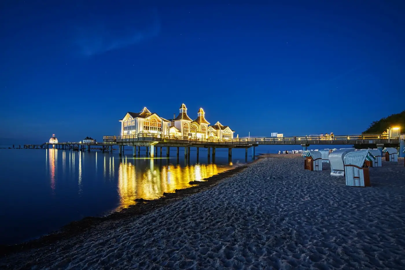 Sellin Pier beautifully illuminated at twilight, reflecting over the Baltic Sea in Germany.