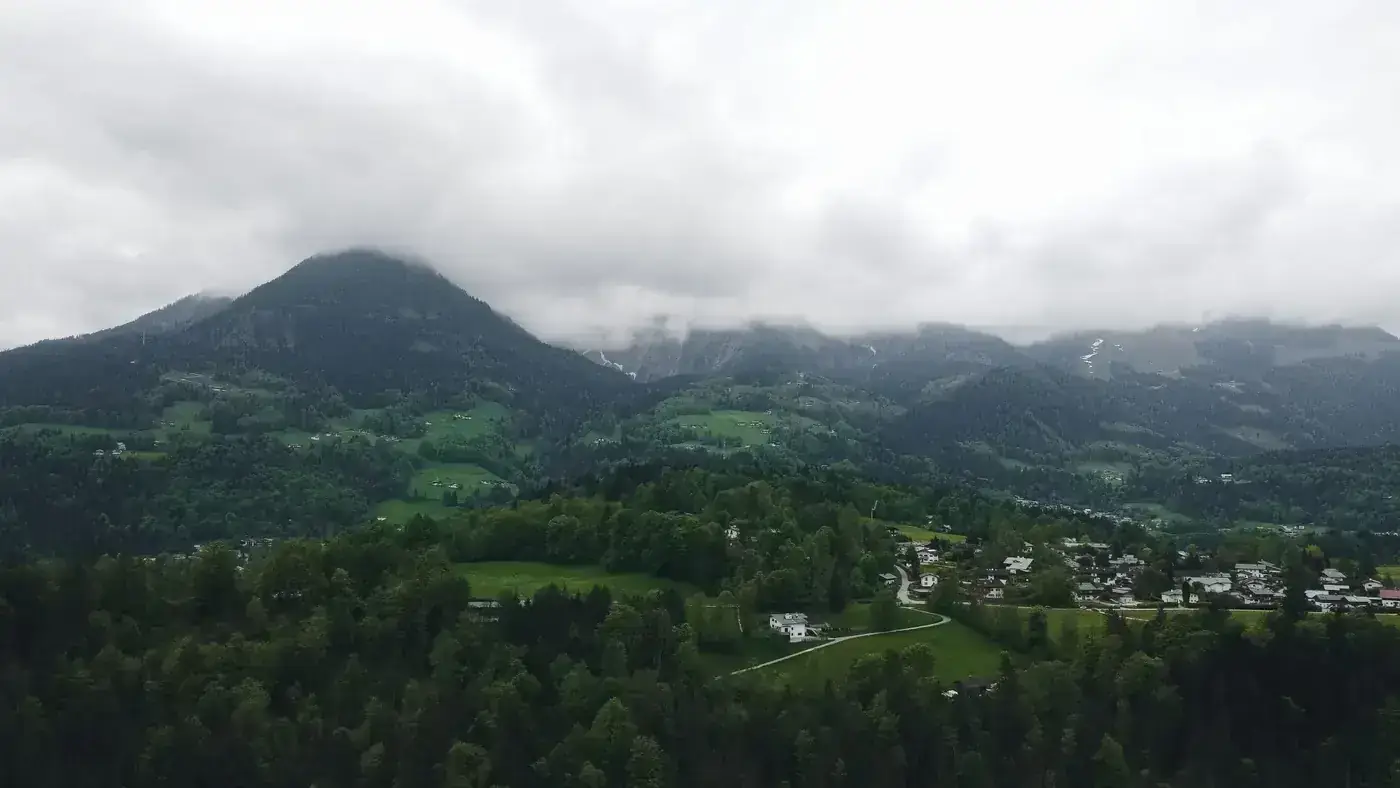 Picturesque landscape of Berchtesgaden, Germany with foggy mountains and lush greenery.
