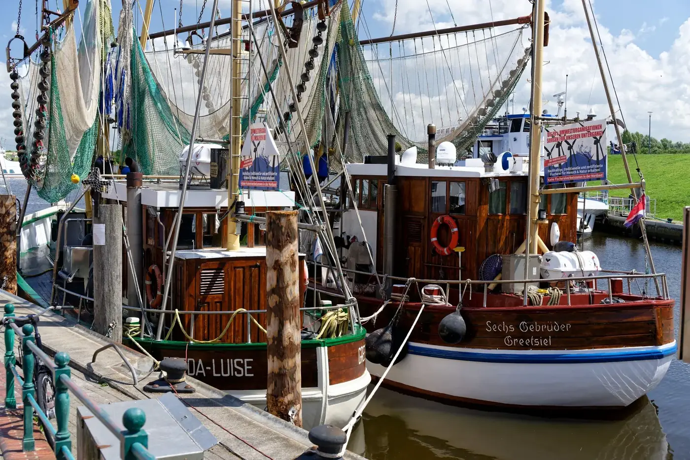 Colorful fishing boats docked in Greetsiel harbor in Krummhörn, Germany.