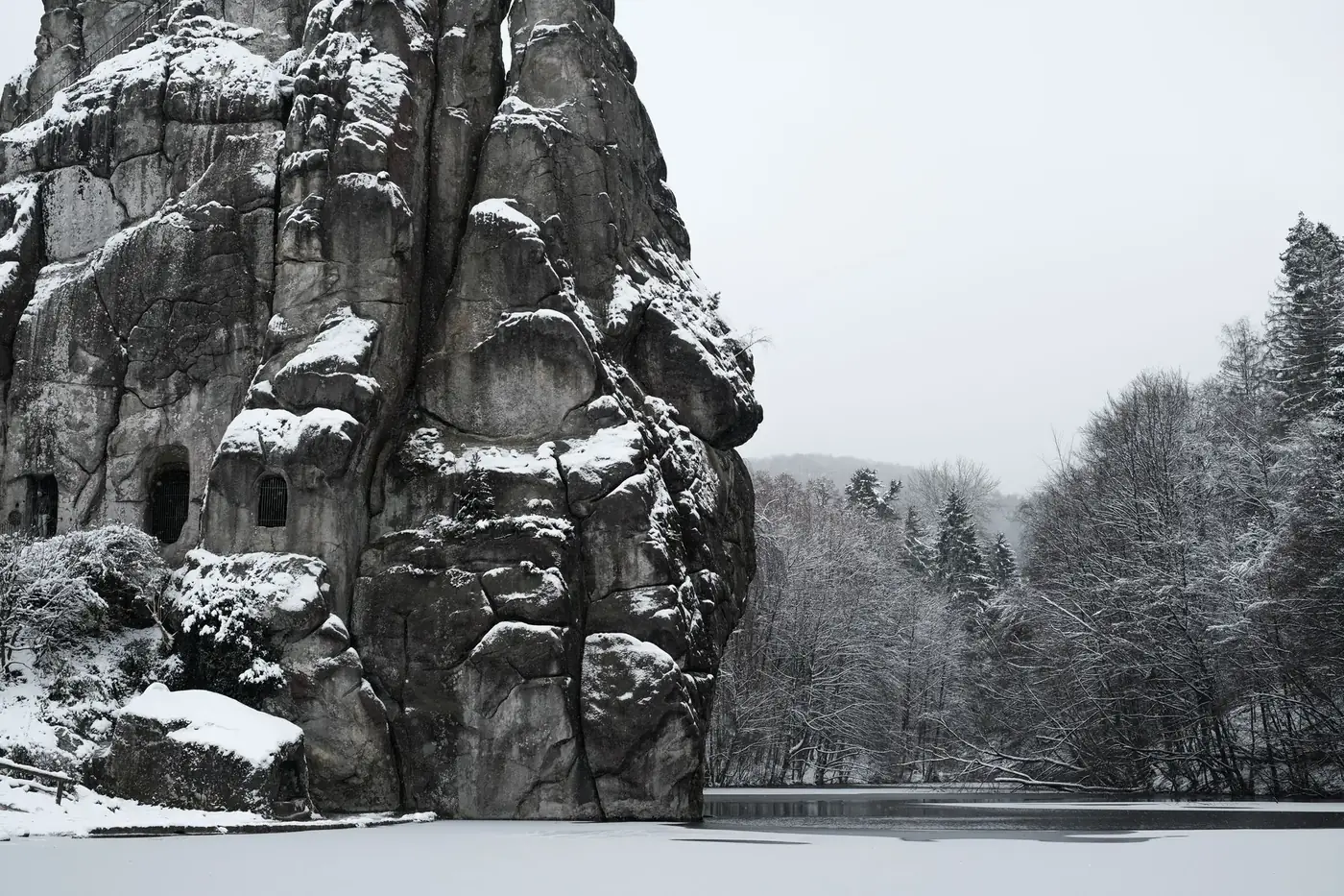 Dramatic snowy landscape of Externsteine rock formation in Germany's Teutoburg Forest.